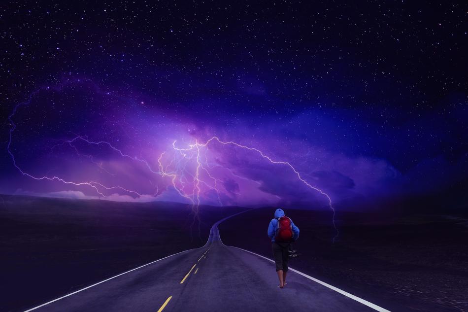 Person on the road, on the beautiful landscape, at purple lightning on background