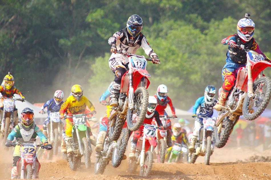 racing on soil road, group of men riding motorbikes