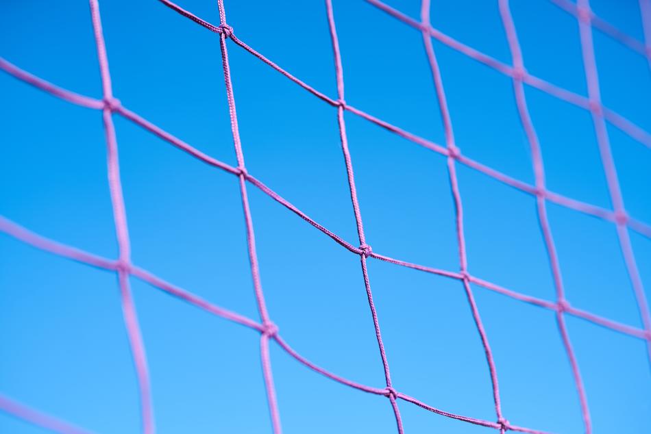 pink volleyball net against the blue sky
