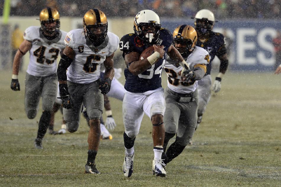 A team of American football players running across the field during a match