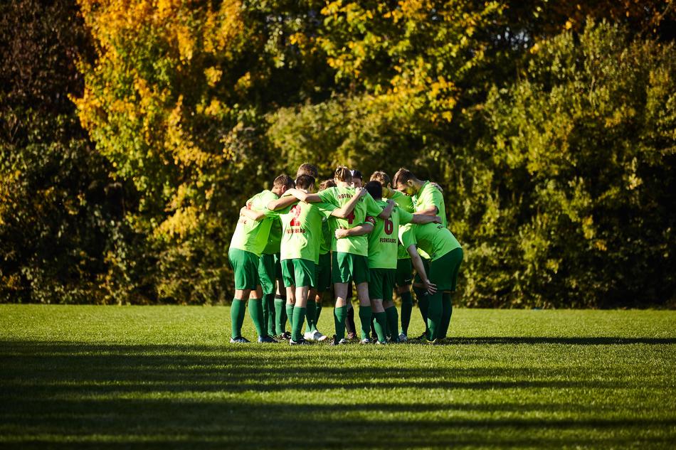 male Soccer team on lawn at autumn