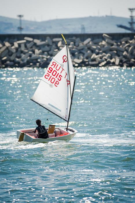 Person, yachting on the red and white yacht, on the beautiful landscape in Burgas, Bulgaria