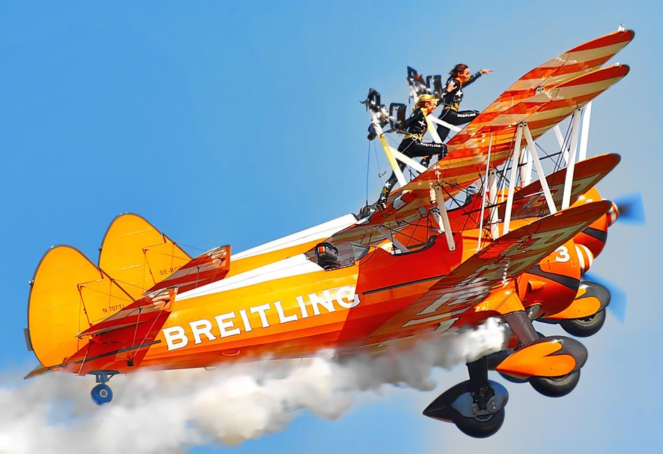 Bi-Plane Aerial Aerobatics in the blue sky close up