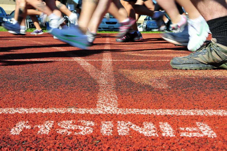 People's legs on the finish on the track