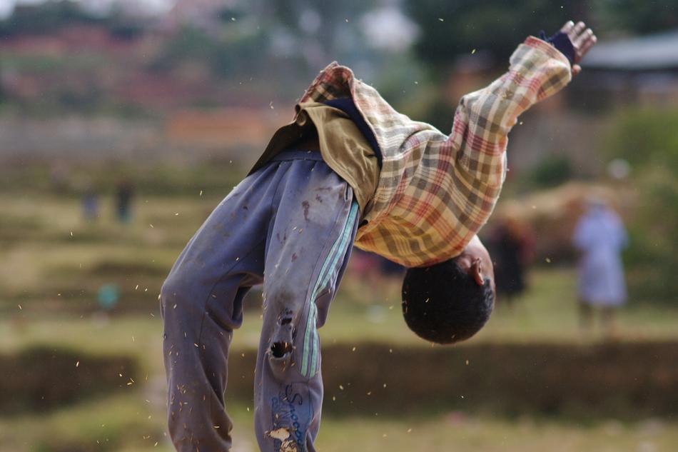 ragged Boy doing Somersault outdoor