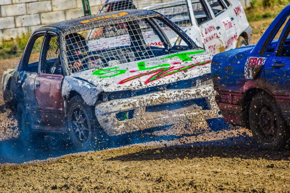 Colorful cars in motion, on the dirt, on the competition