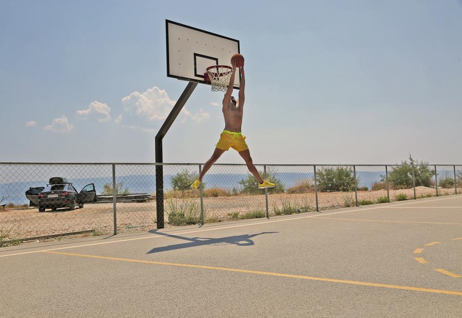 Male, dunking on the basket, on the court