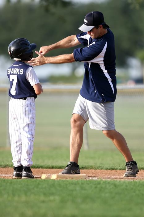 little league coach and young athlete