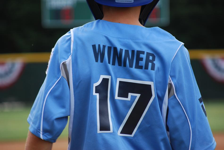 Back view of the baseball boy player with '17' number and 'winner' sign