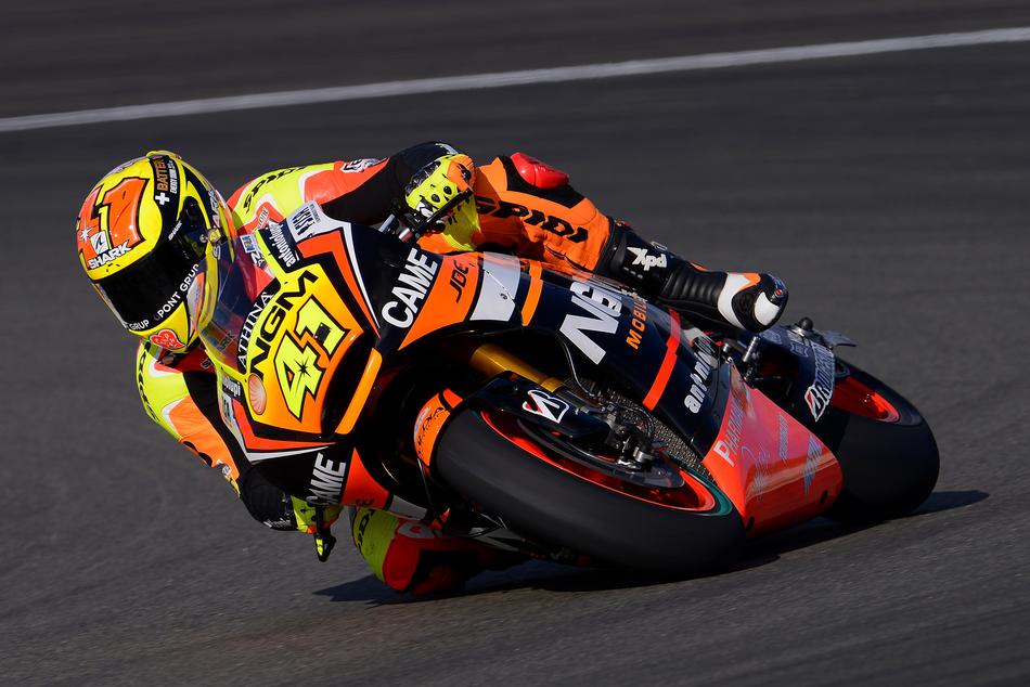 Colorful racer in equipment, on the motorcycle, in motion, on the competition