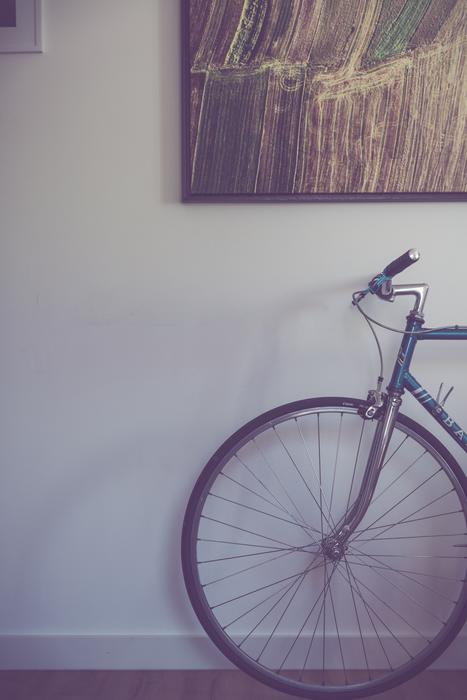 vintage bicycle near the wall with a picture