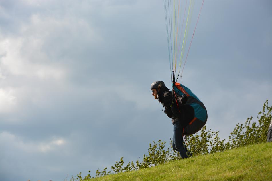 skydiver rises to the sky from the top of the mountain