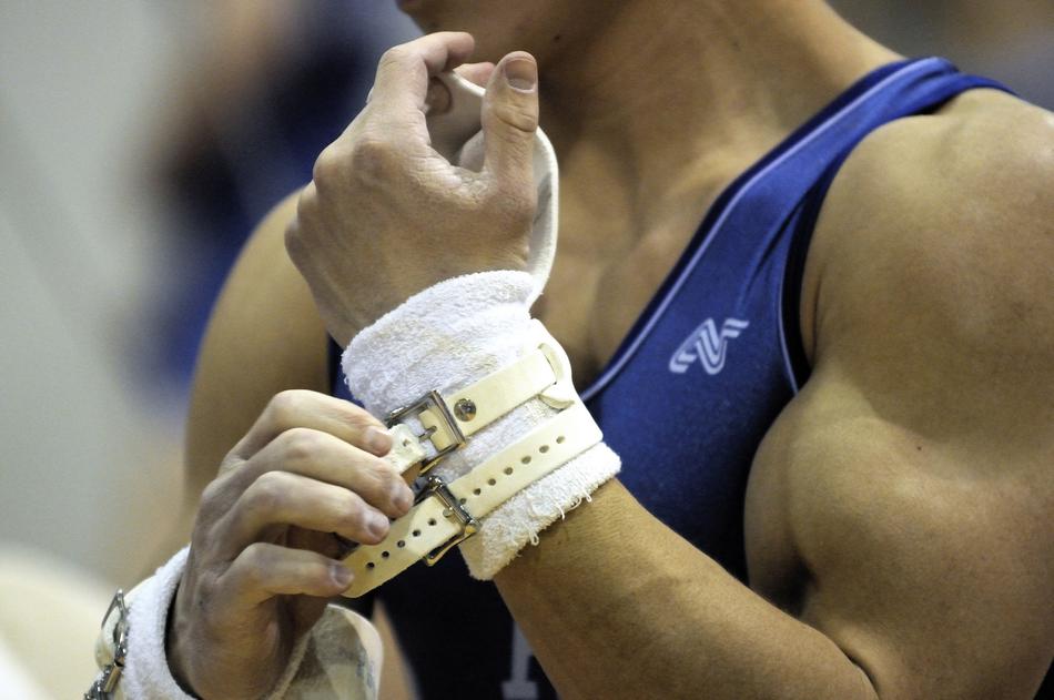 muscular arms of a gymnast close up on a blurred background
