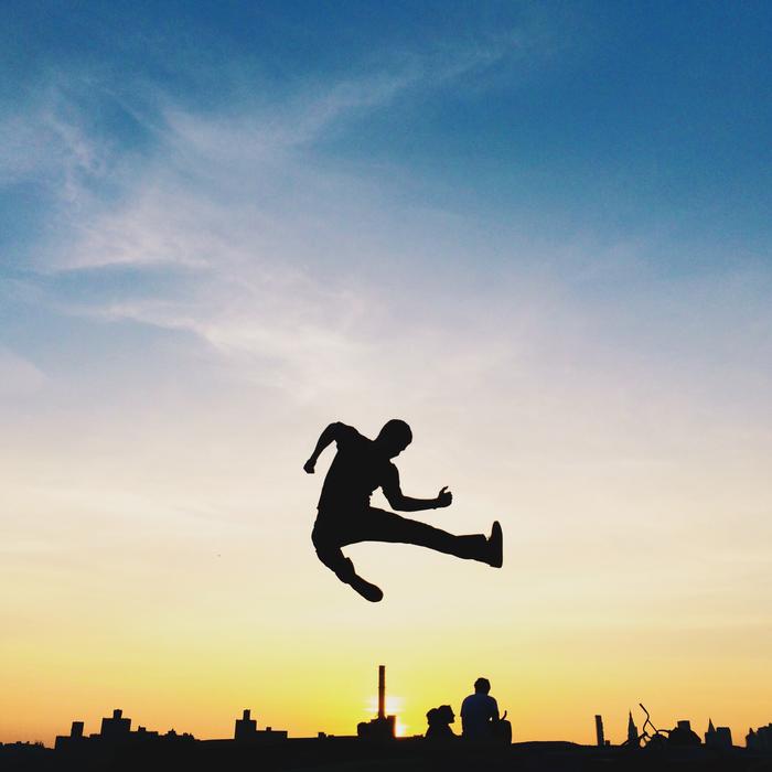 silhouette of a high jump on the background of the city
