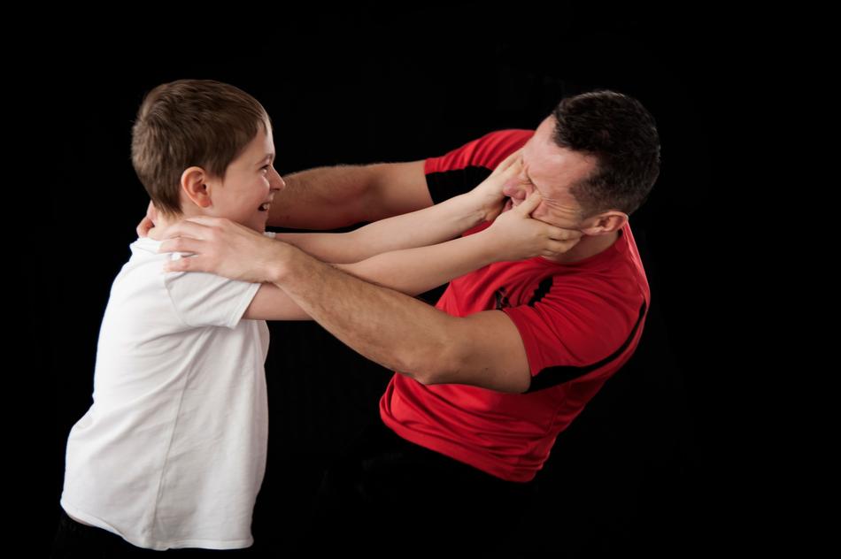 Self defense in Wing Tsun, between the child and man, at black background