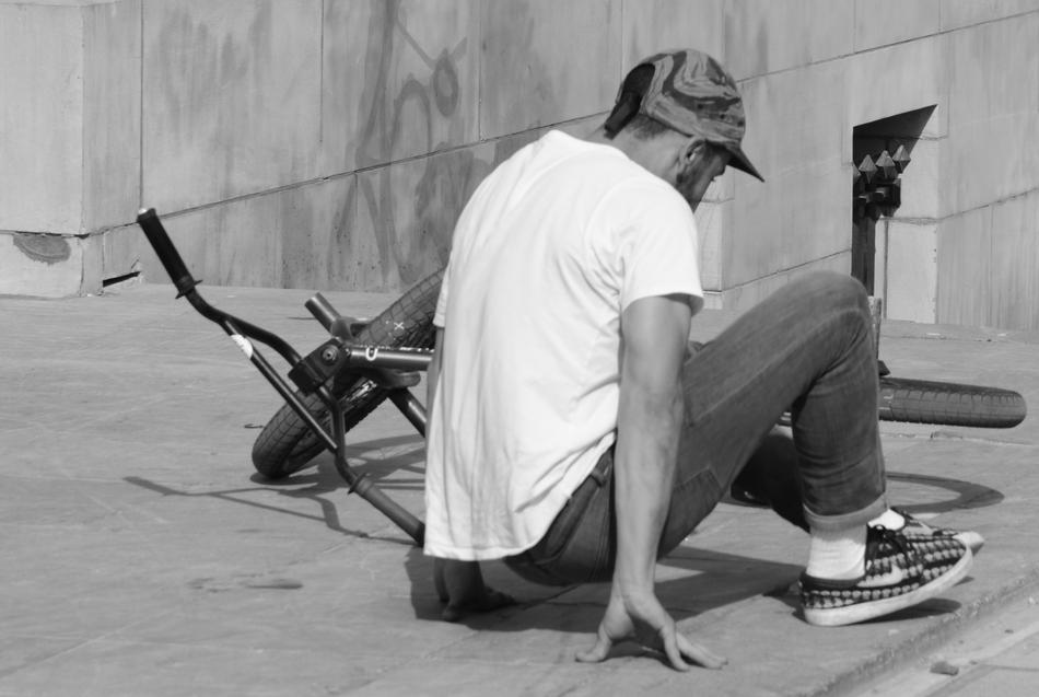 monochrome photo of a fallen cyclist