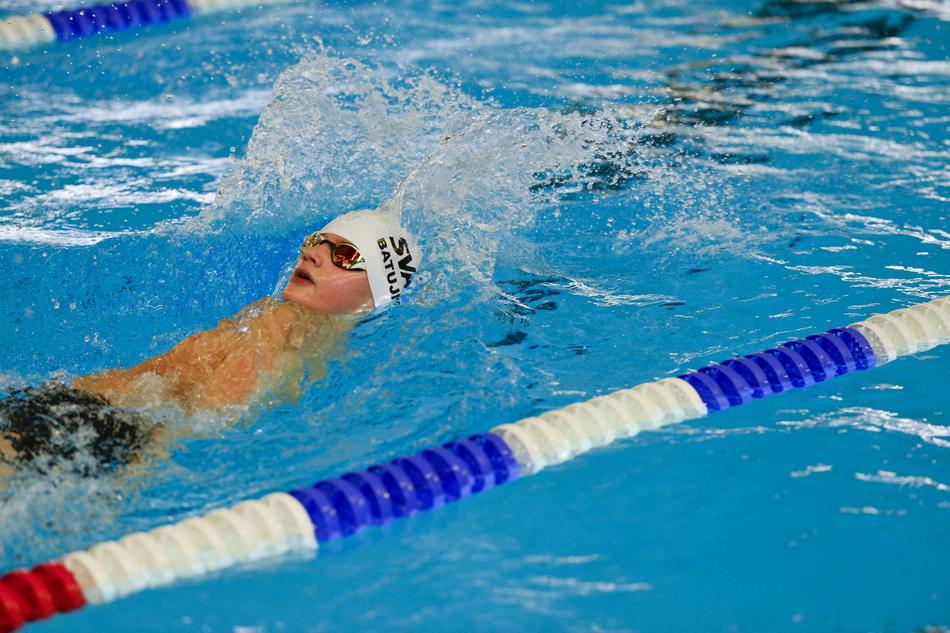 man swims in freestyle style in the pool