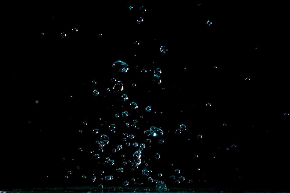 Beautiful, blue water drops at black background