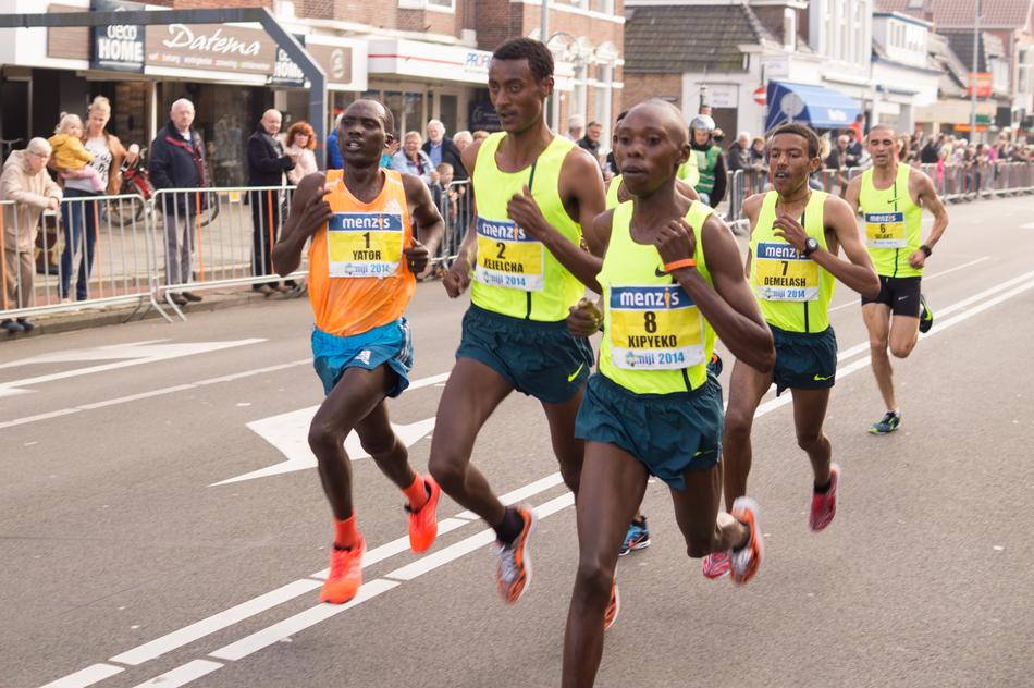 Runners on the road, on marathon with spectators