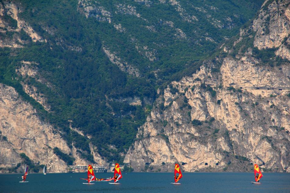 Colorful bots on the beautiful Garda lake, near the mountains in Italy