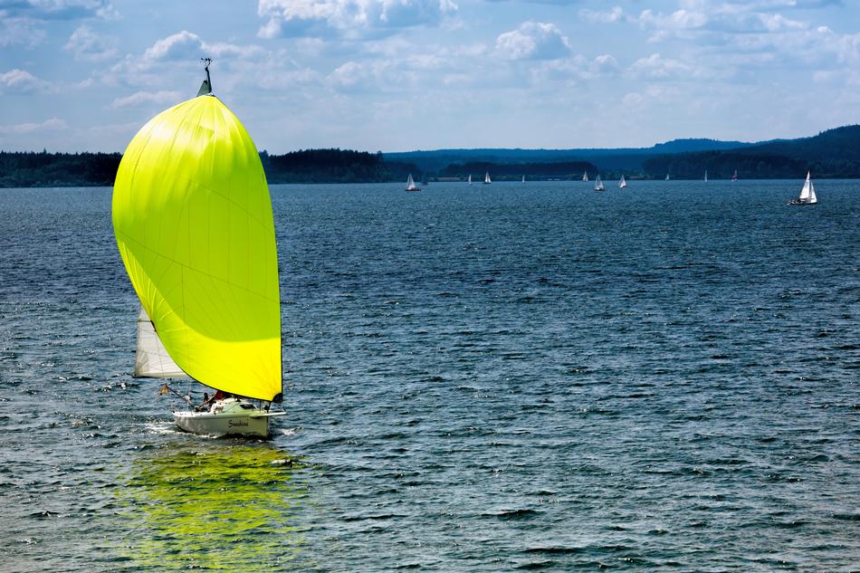 boat with a bright sail on the brombachsee lake