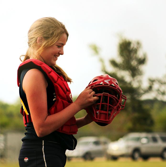 softball helmet in hand