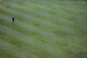 man with lawn mower in the stadium