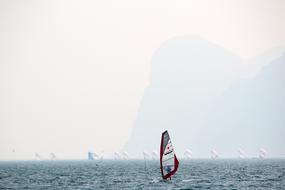 sailboats on lake garda in fog