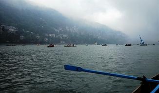 Beautiful view of the mountains under cloudy sky, from the boat, in Nainital, India