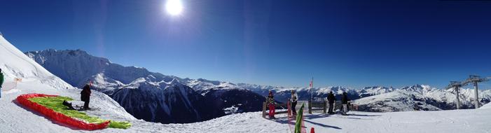 skiers on the top of the mountain in winter