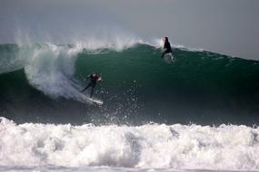 surfers ride the waves of the ocean