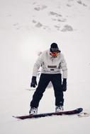 photo of a snowboarder on the background of a snowy slope