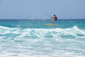 kitesurfer over the waves on a sunny day