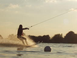 Water Skiing at evening near shore