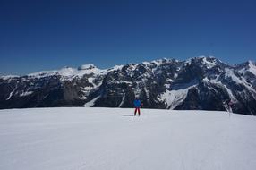 skier on the snow in a mountain valley on a sunny day