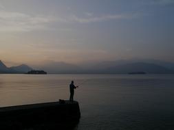 fisherman on the pier at dusk