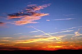 Beautiful and colorful sunrise in the sky, with the clouds, above the landscape