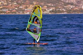 athlete windsurfing on the river