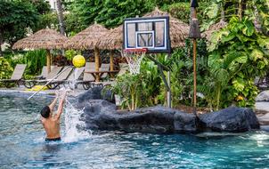 Boy play with ball in water