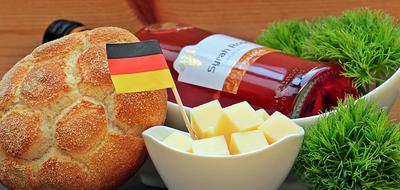 german flag in bowl with cheese cubes, wine and bread