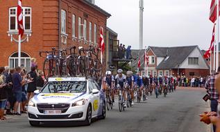 Cyclists and car, on the beautiful street in Ansager, Denmark