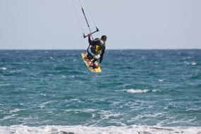 people are kitesurfing at sea