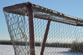 mesh gate on the pond in winter