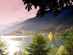 Beautiful lake in sunlight, among the colorful mountains, in Ledro, Italy, at colorful sunset