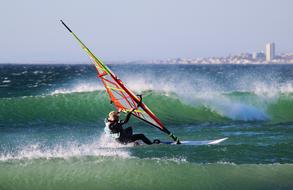 surfer, spray and green ocean waves