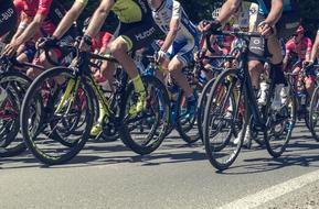 People, cycling on the colorful bikes, on the road, on the competition in Poand