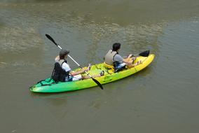 two people in a kayak on the water