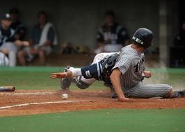 Baseball players, playing on the colorful field, on the college competition