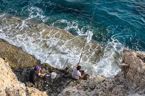 two fishermen by the sea in Ayia Napa, Cyprus