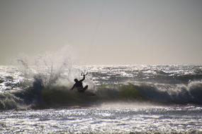 Kitesurfer on stormy wave